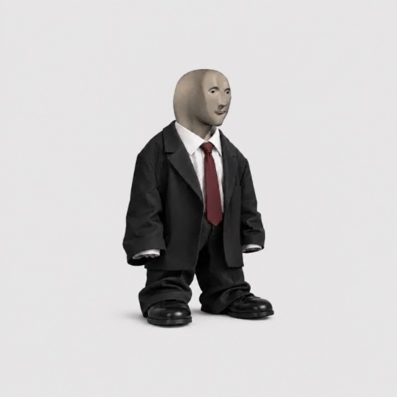 The $suit character: a meme-man head on a small figure in a black suit, white shirt and red tie